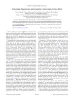 Strain tuning of quantum dot optical transitions via laser-induced surface defects