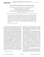 Fiber-Coupled Cavity-QED Source of Identical Single Photons